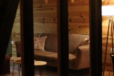 a couch in a room with a wooden wall at Camp Oaza,Lipa in Cetinje