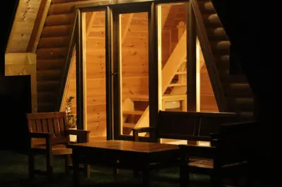 a wooden table and chairs in a room with a staircase at Camp Oaza,Lipa in Cetinje