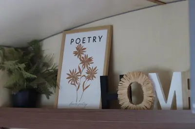 a wooden shelf with a picture and a sign on it at Camp Oaza,Lipa in Cetinje