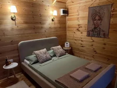 a bedroom with a bed in a wooden wall at Camp Oaza,Lipa in Cetinje