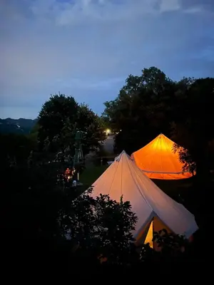two tents sitting in a field at night at Camp Oaza,Lipa in Cetinje