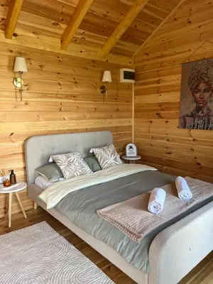 a bedroom with a bed in a wooden wall at Camp Oaza,Lipa in Cetinje