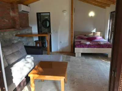 a living room with a bed and a coffee table at Olive Paradise in Ulcinj