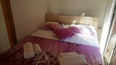 a bedroom with a bed with pillows on it at Olive Paradise in Ulcinj