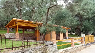a pavilion in a park next to a fence at Olive Paradise in Ulcinj