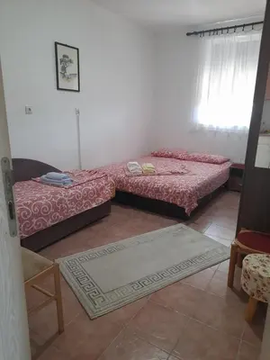a living room with two beds and a window at Apartman SB in Ulcinj