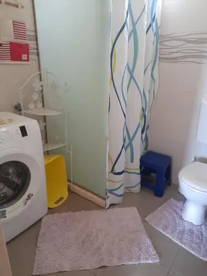 a bathroom with a washing machine and a toilet at Apartman SB in Ulcinj