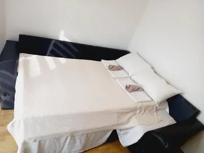 a black couch with two white pillows on it at B4 in Budva