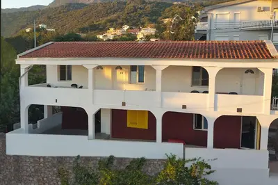 a large white house with a red roof at Diamond by EXCLUSIVE Collection Sea view apartments in Dobra Voda