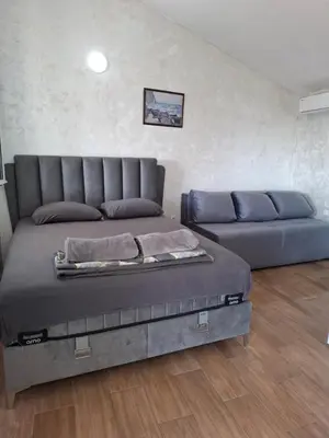 a bed and a couch in a room at Diamond by EXCLUSIVE Collection Sea view apartments in Dobra Voda