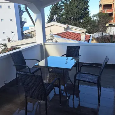 a small table and chairs on a balcony at Diamond by EXCLUSIVE Collection Sea view apartments in Dobra Voda