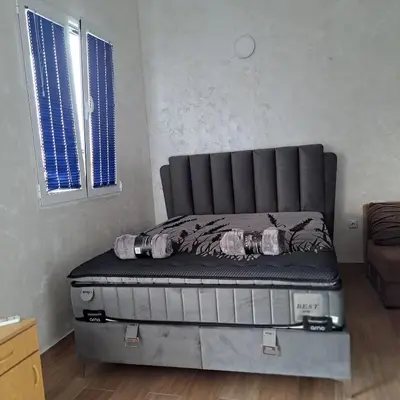 a bed sitting in a room next to two windows at Diamond by EXCLUSIVE Collection Sea view apartments in Dobra Voda