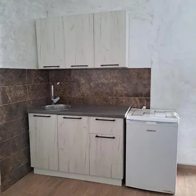 a kitchen with white cabinets and a sink and a dishwasher at Diamond by EXCLUSIVE Collection Sea view apartments in Dobra Voda