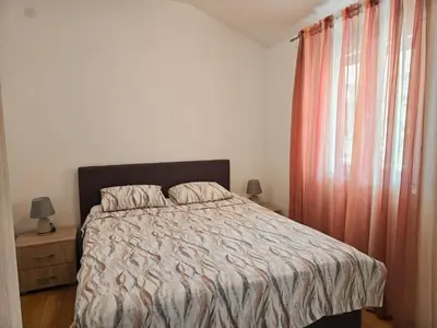 a bedroom with a bed and a window at Village experience - Skadar lake in Virpazar