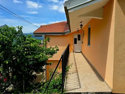 a house with a walkway leading to a door at Village experience - Skadar lake in Virpazar