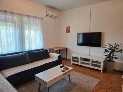 a living room with a couch and a flat screen tv at Village experience - Skadar lake in Virpazar