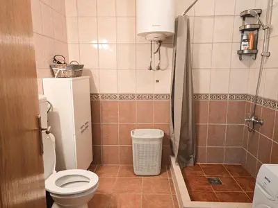 a small bathroom with a toilet and a shower at Village experience - Skadar lake in Virpazar
