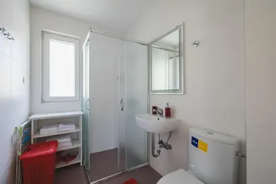 a bathroom with a shower and a sink and a toilet at Villas Promis in Čanj