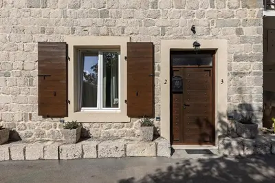 a brick building with a door and a window at VerDi in Kotor