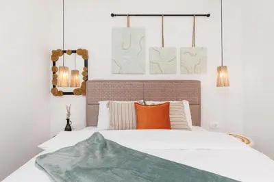 a bedroom with a white bed with orange pillows at VerDi in Kotor