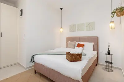 a bedroom with a large bed with a basket on it at VerDi in Kotor
