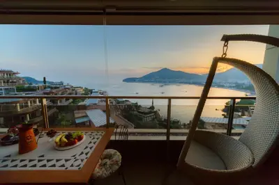 a table with a plate of food on a balcony at HarMony apartment in Budva