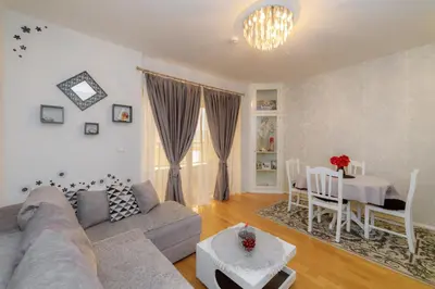 a living room with a couch and a table at HarMony apartment in Budva