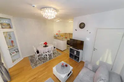 a living room with a couch and a table at HarMony apartment in Budva