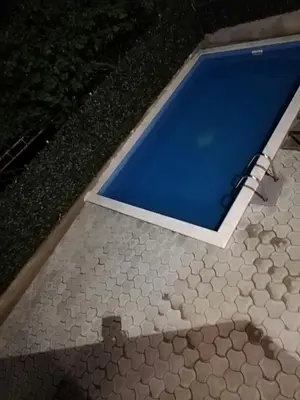 a small swimming pool with a tiled floor at Kevin-Talisa Villa in Bar