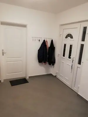a room with a door and shoes hanging on the wall at Kevin-Talisa Villa in Bar