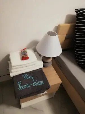 a table with a lamp and a pile of towels at Kevin-Talisa Villa in Bar