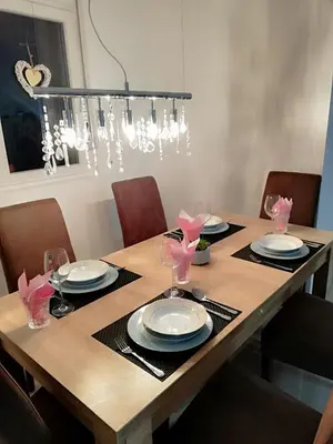 a dining room table with chairs and a chandelier at Kevin-Talisa Villa in Bar