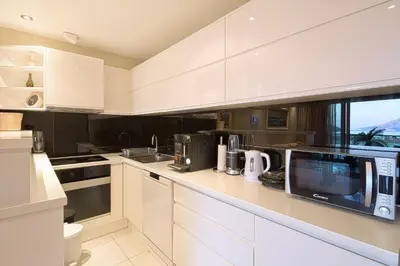 a kitchen with white cabinets and a microwave at Premier LUX apartment in Budva