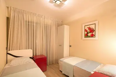 a hotel room with two beds and a window at Premier LUX apartment in Budva