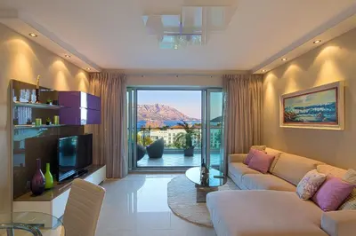 a living room with a couch and a television at Premier LUX apartment in Budva