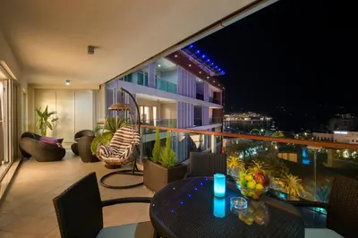 a balcony with a table and chairs on a building at Premier LUX apartment in Budva