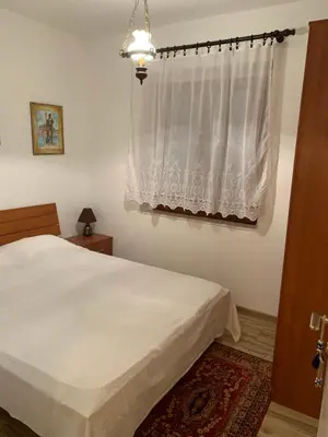 a bedroom with a white bed and a window at Sea forever in Petrovac na Moru