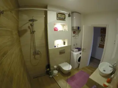 a bathroom with a shower with a toilet and a sink at Sea forever in Petrovac na Moru