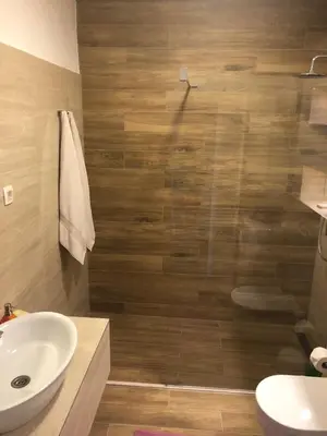 a bathroom with a sink and a glass shower at Sea forever in Petrovac na Moru