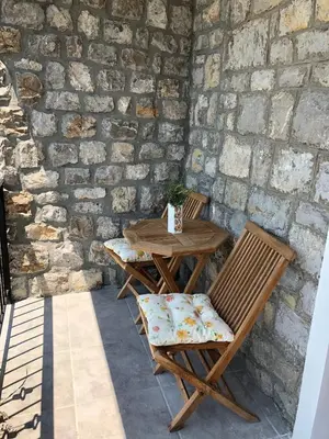 a wooden table and two chairs on a patio at Sea forever in Petrovac na Moru