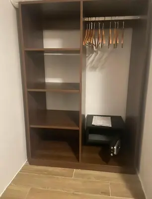 a walk in closet with a wooden closet organizer at Reina in Petrovac na Moru