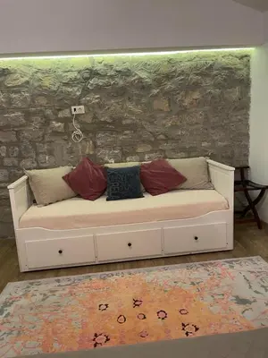 a white couch with pillows on it in a room at Reina in Petrovac na Moru