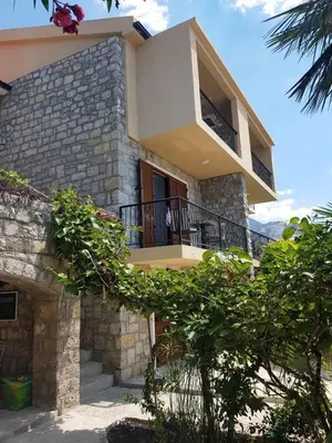 a building with a balcony with a person on the balcony at Reina in Petrovac na Moru