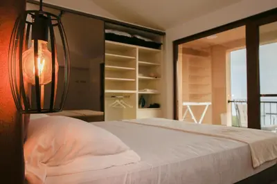 a bedroom with a bed with a lamp on it at Reina in Petrovac na Moru