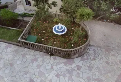 a garden with a blue and white sign on it at Apartments Svorcan in Budva
