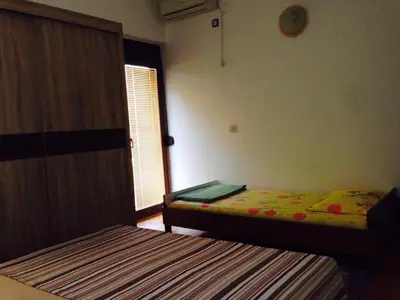 a bedroom with two beds and a window at Apartments Svorcan in Budva