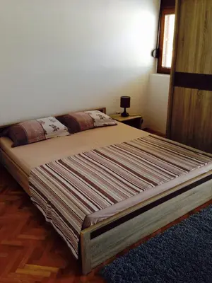 a large bed in a bedroom with at Apartments Svorcan in Budva