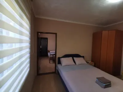a small bedroom with a bed and a mirror at Bar-Apartman 2 in Bar