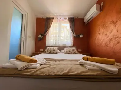a bedroom with a bed with towels on it at Apart dom Janković in Sutomore