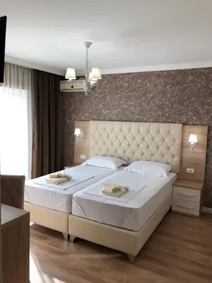 a bedroom with a large bed with a large headboard at 